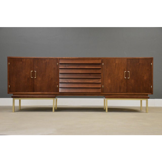 A mid century modern walnut dresser designed by Merton Gershun for American of Martinsville with louvered drawers and...