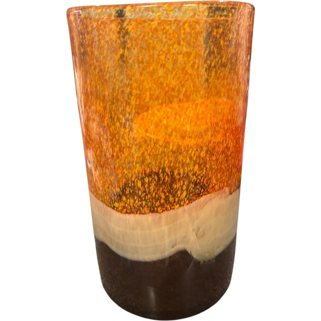 A striking vintage Pier 1 art glass hurricane candle holder featuring a dramatic layered palette of fiery amber and...