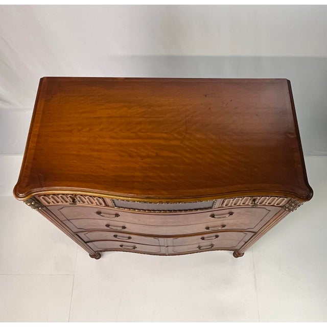 This sophisticated Neoclassical chest of drawers offers a commanding presence, blending architectural rigor with the...