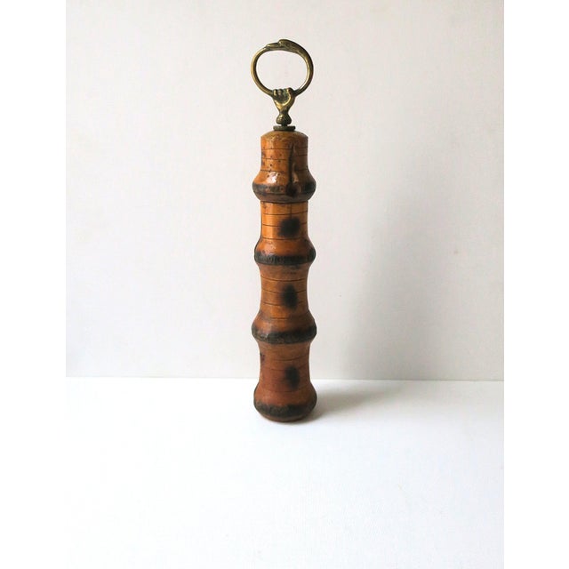 An Italian wood bamboo peppermill with brass hand fist detail, circa mid-20th century, Italy. An Italian, wood pepper mill...