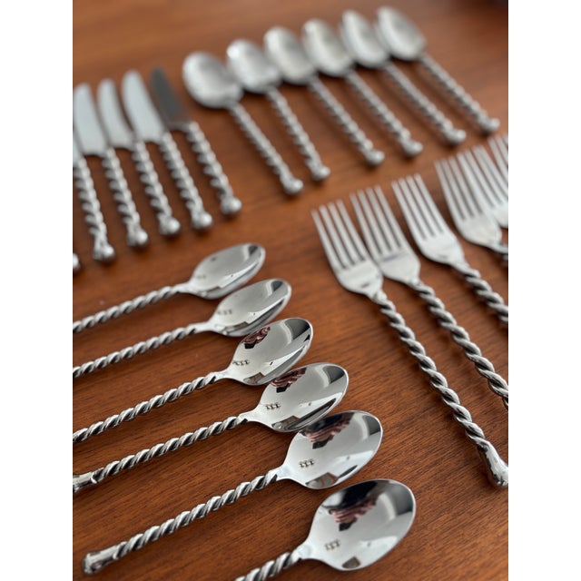 Elegant stainless steel cutlery set, featuring twisted handles and a timeless, graphic design. Both understated and...