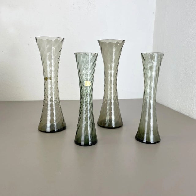 Set of four crystal vases Producer: Alfred Taube Kristallglasfabrik, Germany Decade: 1960s These original vintage vases...