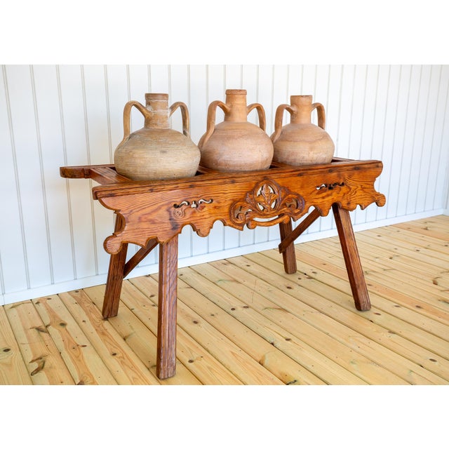 A strikingly attractive, extremely rare and wonderfully decorative carved oak amphora stand with three terracotta amphorae...