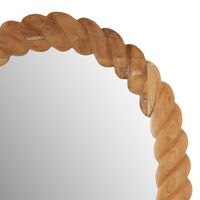 Beautifully sculpted teak wood mirror featuring a distinctive twisted, rope-inspired design. The warm natural wood tones...