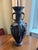 A pair of antique Japanese patinated bronze vases from the late 19th century featuring high-relief bird and floral motifs....