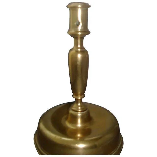 A fine and rare 17th century Spanish or French brass candlestick with bulbous base and finely shaped baluster stem. Nozzle...