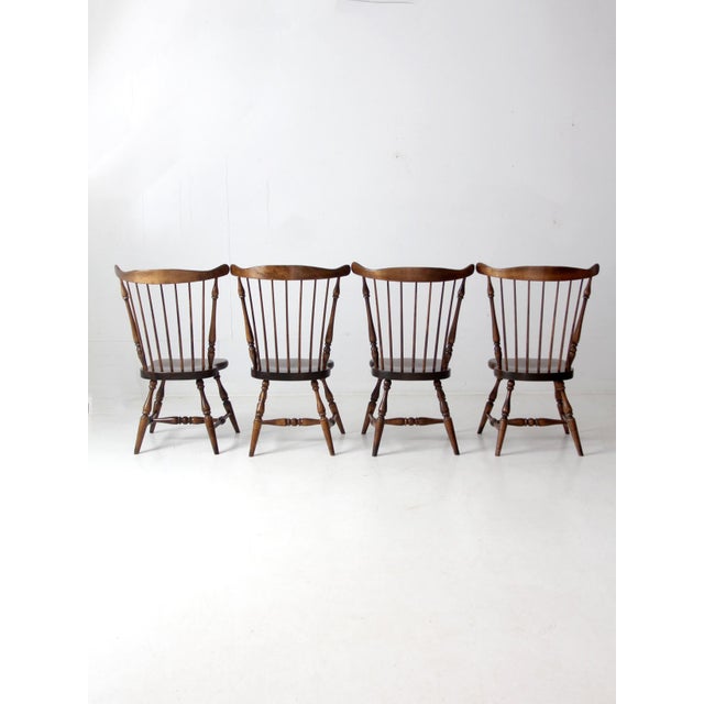 These set of 4 vintage American Windsor wood chairs offer timeless elegance. Featuring a distinctive spindle back, curved...