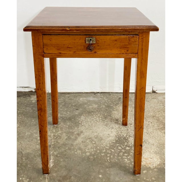Antique primitive wood side table with single drawer. Made from what appears to be birds eye maple with a refinished top....