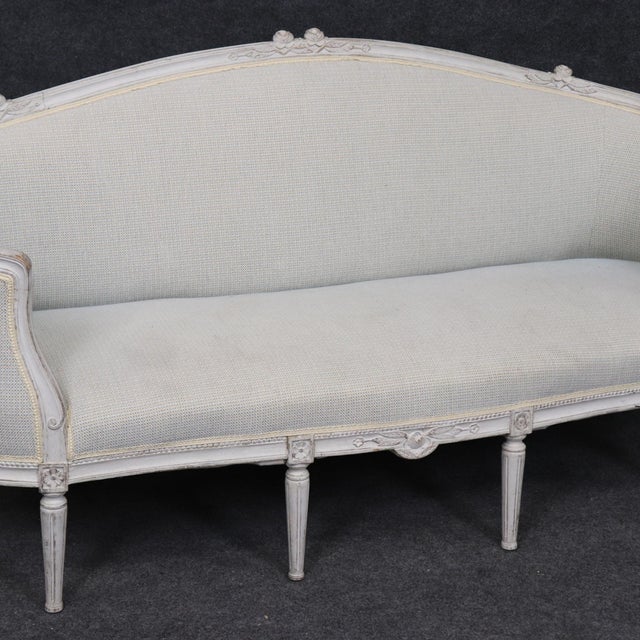 This is a superb Corbeille Form French Carved walnut painted canape sofa or settee. The piece dates to the 1940s era and...