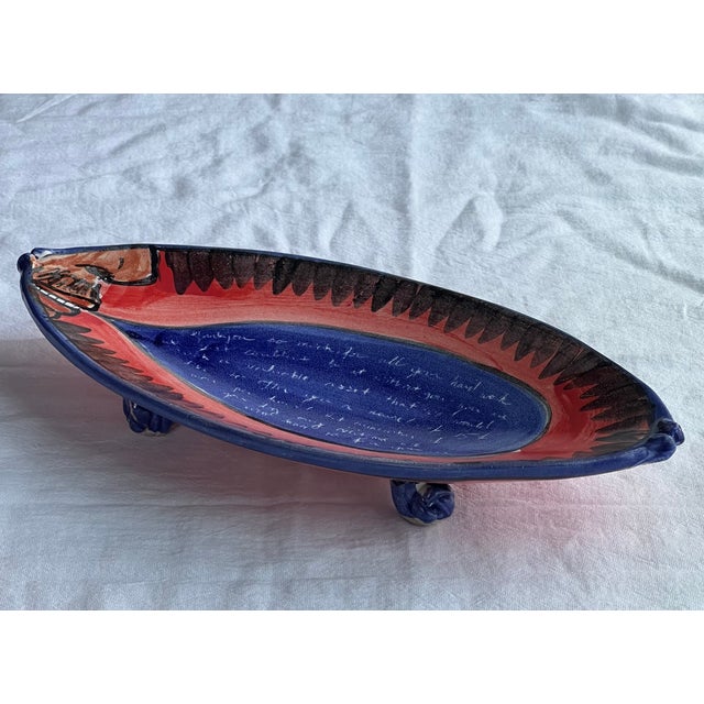 An interesting handmade and hand painted art bowl titled "I Quit", red and blue with the profile of a man in one corner...