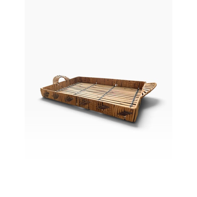 Vintage woven bamboo and rattan serving tray featuring a rectangular slatted construction with raised sides and...