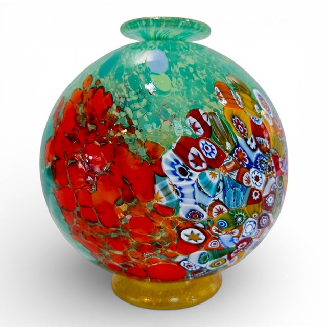 A stunning handblown Murano art glass vase featuring the iconic Millefiori design in vivid reds, blues, greens, and gold....