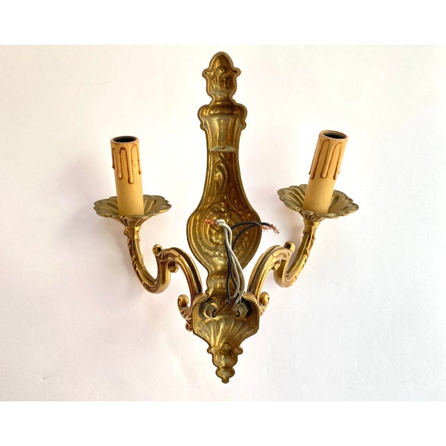 Vintage Twin-Arm bronze wall lamp from France imitate classic candelabra, circa 1960s. There is a mark on the sconce. The...