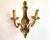 Vintage Twin-Arm bronze wall lamp from France imitate classic candelabra, circa 1960s. There is a mark on the sconce. The...