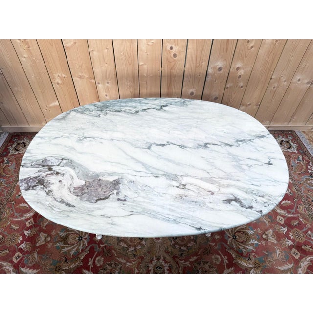 Art Nouveau bistro table, Belle Époque period, circa 1890-1910, with an oval veined marble top and a lacquered cast iron...