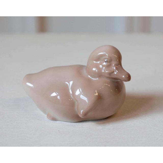 A charming porcelain duckling by Royal Copenhagen, renowned for its exceptional Danish craftsmanship and delicate...