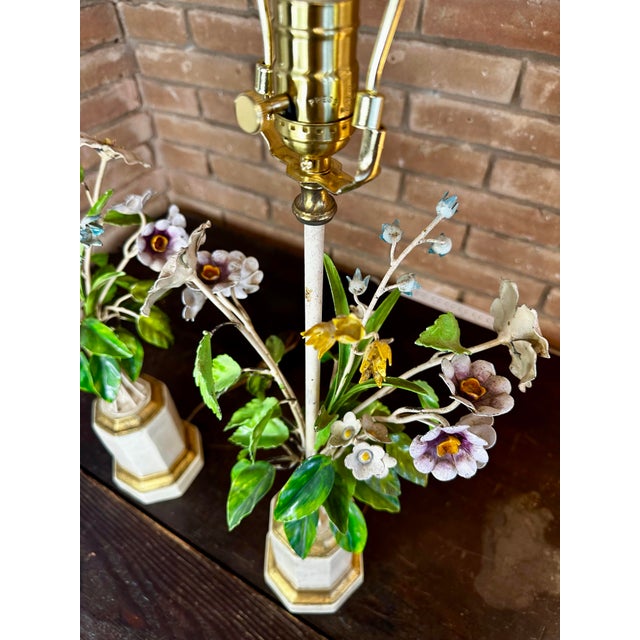 Striking pair of 1960s Italian Tole and porcelain floral table lamps with original finials. The stems and leaves are made...