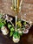 Striking pair of 1960s Italian Tole and porcelain floral table lamps with original finials. The stems and leaves are made...