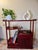 • Hand-carved pierced fretwork galleries in a scrolling foliate motif • A floating upper shelf with its own curled end,...