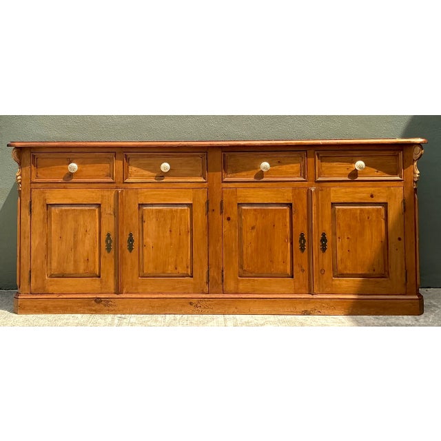 Crafted from solid knotty pine, this vintage sideboard credenza captures quintessential rustic charm paired with refined...