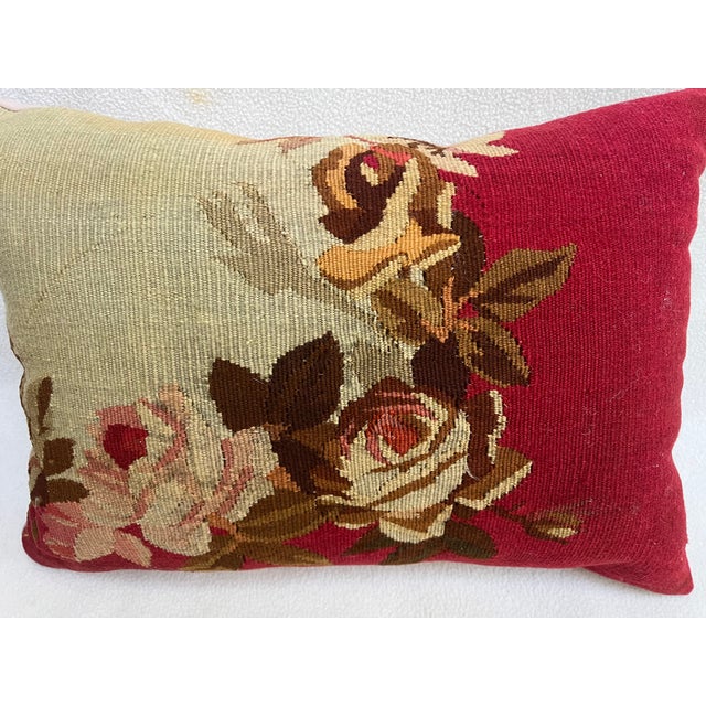 Decorative pillow upholstered in richly woven 19th century Aubusson tapestry, adorned with an elegant floral motif. A...