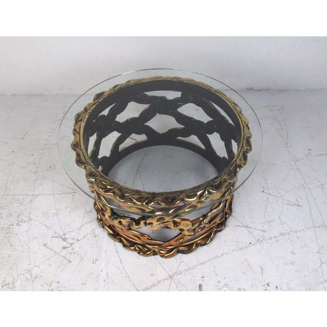 This fabulous vintage modern cocktail table features an unusual sculpted base made of epoxy resin and a round thick glass...