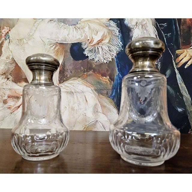 Pair of antique Louis XVI style crystal and silver bottles, finely engraved and decorated with delicate floral motifs....