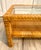 Here is a beautiful later mid-century two-tier coffee table featuring a rectangular woven rattan frame, inset glass top...