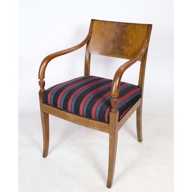 A pair of danish empire style hand-polished mahogany armchairs with striped fabric from around the 1920s. Measurements in...