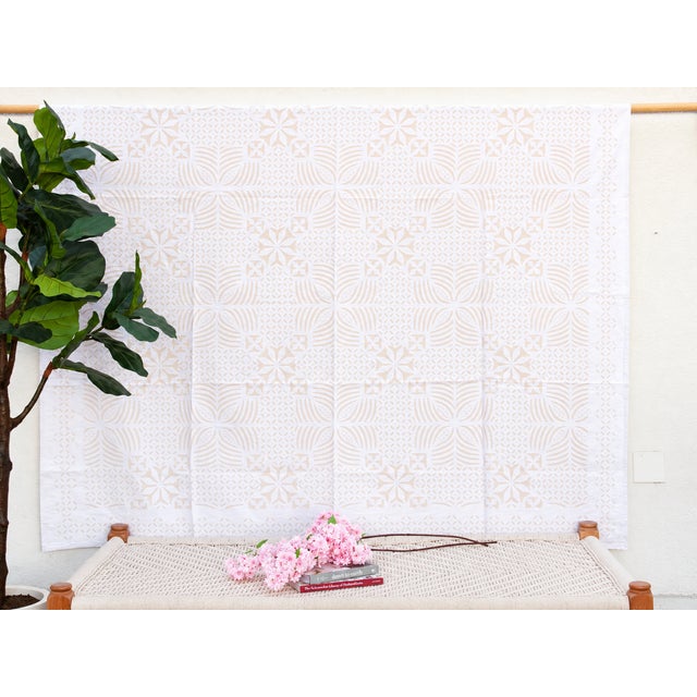A lightweight cotton coverlet from Western India, beautifully adorned with intricate handcrafted appliqué cutwork. The...