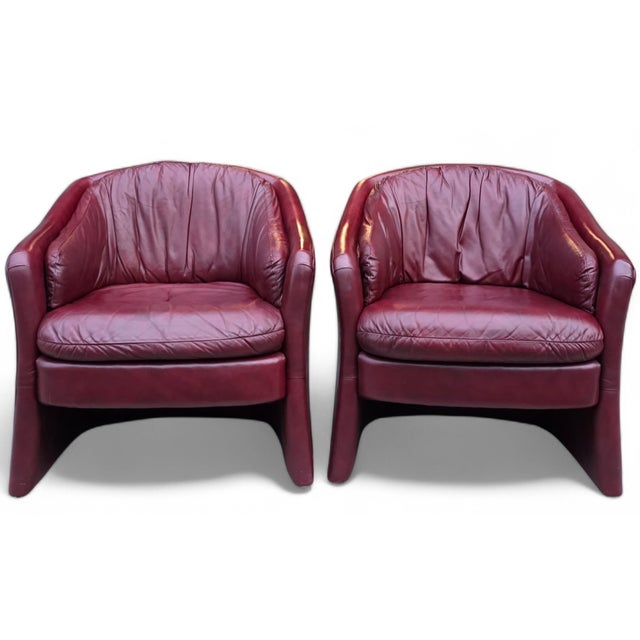 Featured is a Pair of Vintage Oxblood Leathercraft Postmodern Lounge/Club Chairs. These chairs boast a sculptural, rounded...