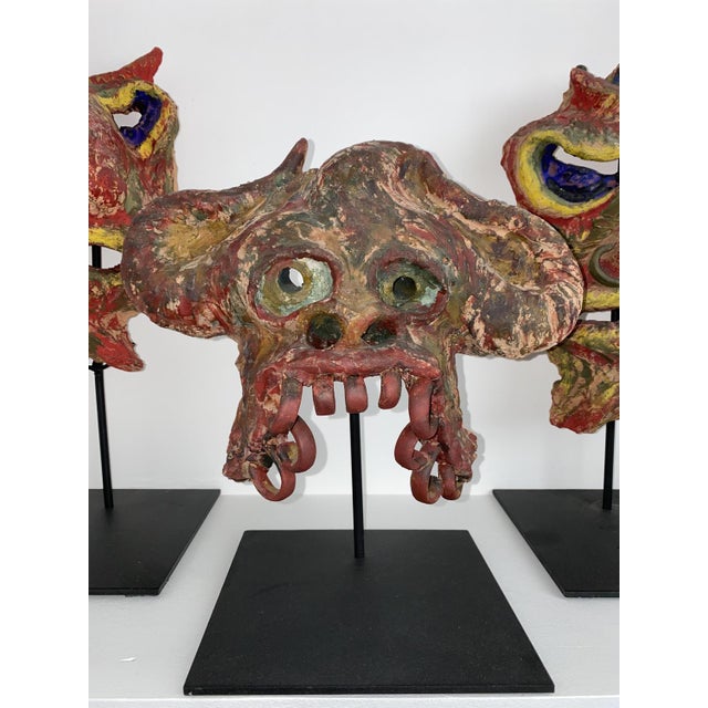 Angelo meani 1906-1977, very rare set of 3 art brut masks, in freehand painted terracotta and dated 1953. meani often...