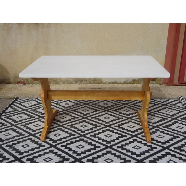 Pine dining table with monastery-style legs. The tabletop is painted white and protected with a colorless, water-...