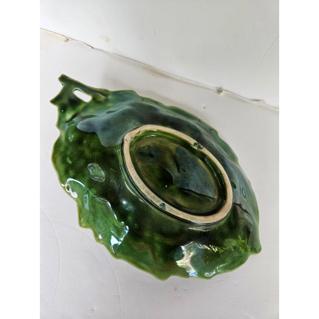 Charming serving dish suitable for sauce, nuts, chutney etc. Green leaf with a plum handle. From a prominent designers...