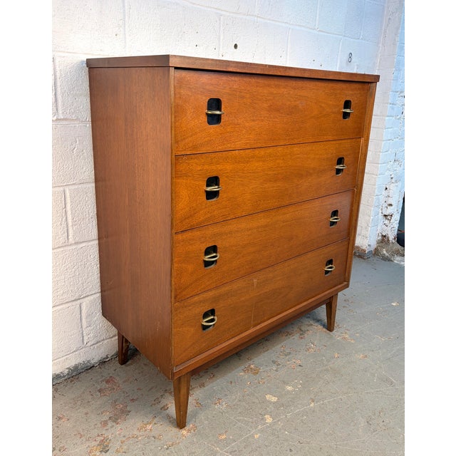 A refined American mid-century modern four-drawer chest produced by Bassett Furniture Industries, Inc., circa 1960s....