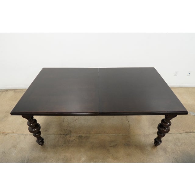 This traditional-style dining table features a rich dark wood finish and classic turned legs that give it a timeless,...