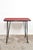 Nice 60s side table with striking steel legs on wheels. There is a red with black stripes, cotton/linen-like material on...