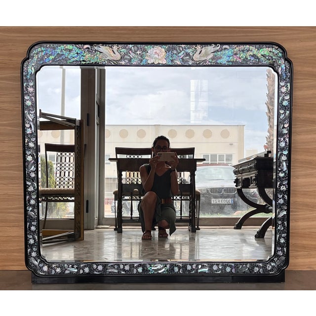 Chinese export lacquer and hardstone mirror, with various hardstone floral inlays in a black lacquer cartouche frame....