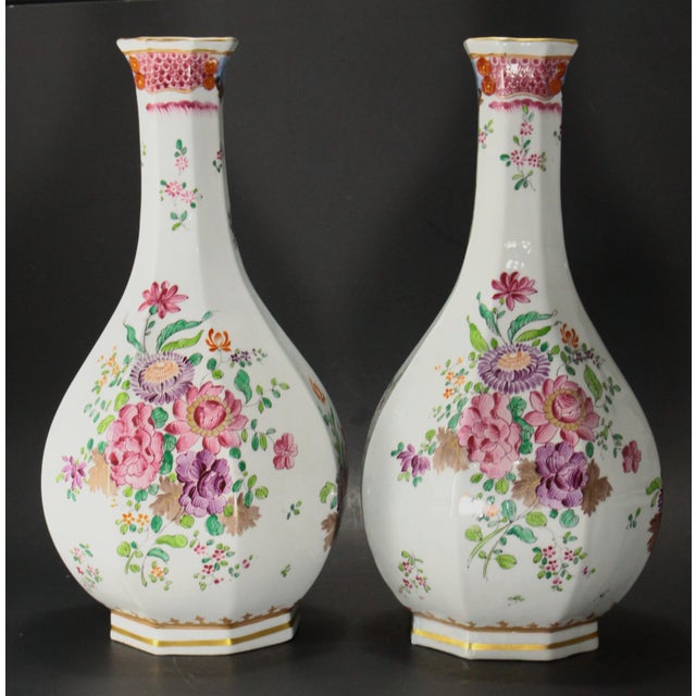 An impressive pair of porcelain vases Decorated by hand in the traditions of the Famille Rose Chinese porcelain, with...