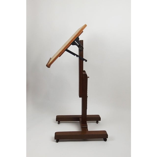 Oak drawing table mounted on casters with adjustable height, and a tilting beech and birch top. Marked on the back:...