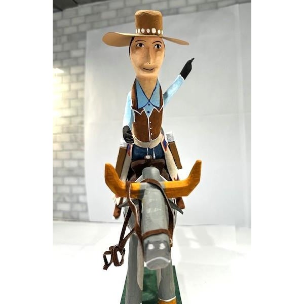 This whimsical and unique large Navajo wood carving featuring a Cowboy on a Bucking Bull with colorful and intricate...
