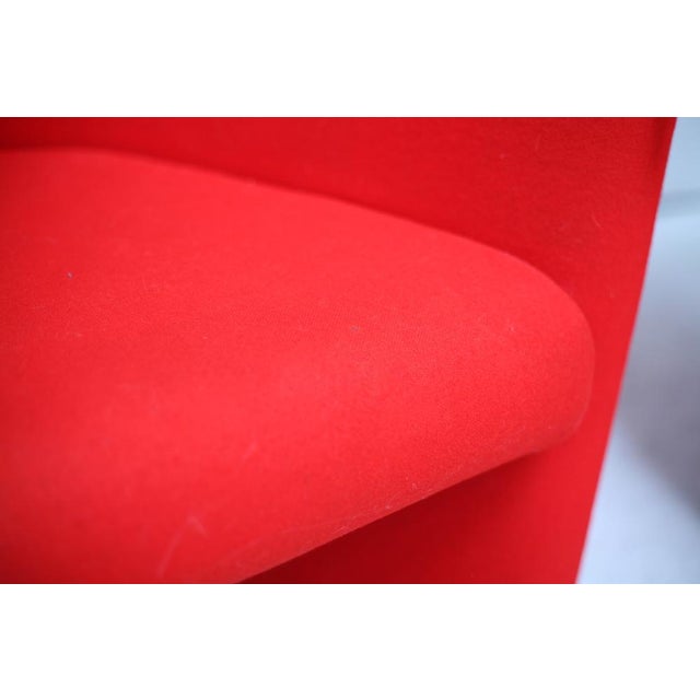 Pair of Arflex red armchairs. Italy, Circa 1980. Rollers at the back, feet at the front. Very discreet small spots. See...