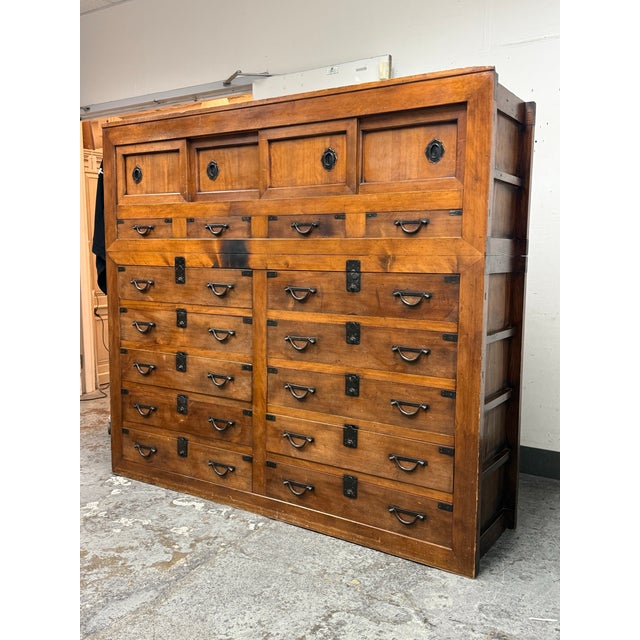 Design Plus Gallery presents a Two-Piece Japanese Tansu Chest of Drawers. The upper section includes sliding doors that...