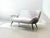 Elegant vintage two-seater sofa in the characteristic mid-century style of the 1950s. The design is distinguished by its...