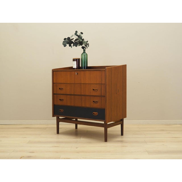 The dressing table was made in the 1970s in Denmark. The structure is covered with teak veneer. The legs and handles are...