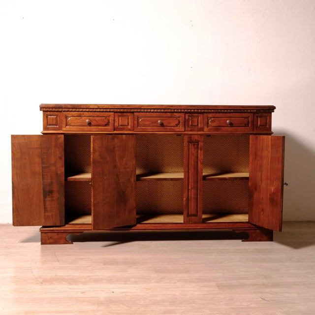Beautiful antique walnut sideboard, Italian made in the 1940s and 1950s. It features three compartments with doors,...