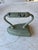Heavy Cast Iron painted light green. Use as display or door stopper.