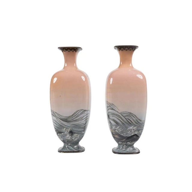Presenting a truly captivating and highly collectible pair of Meiji Period Japanese Cloisonné Enamel Pink-Ground Vases,...