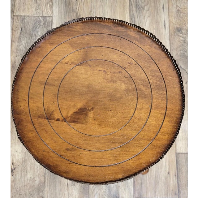 This is a beautiful vintage side table or plant stand with an ornately turned base and metal gallery, with elements of...