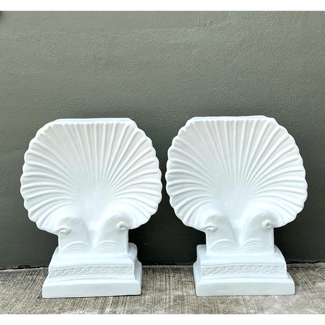 This pair of vintage cast fiber concrete pedestals is a sculptural tribute to the scallop shell, rendered in a clean,...